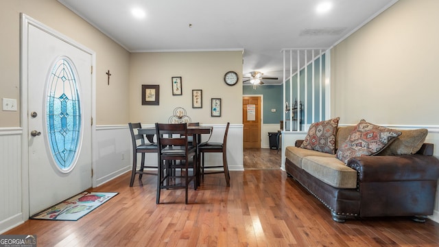 interior space featuring hardwood / wood-style floors, crown molding, and ceiling fan