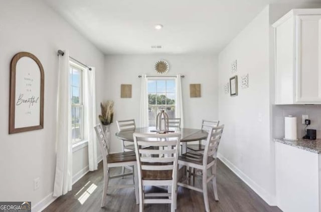 dining space with dark hardwood / wood-style flooring