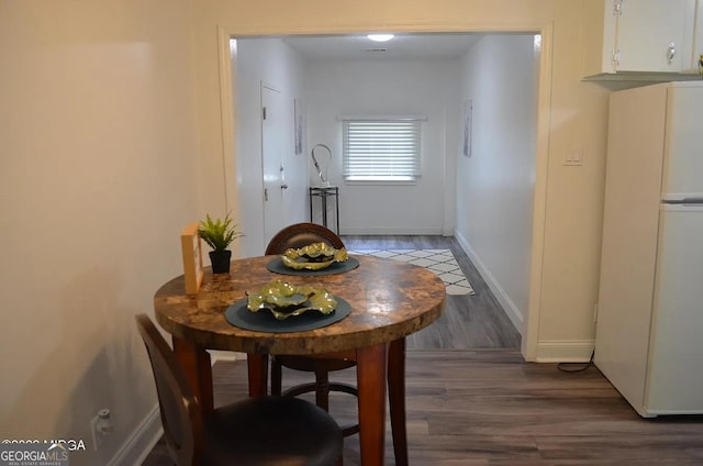 dining area featuring dark hardwood / wood-style floors