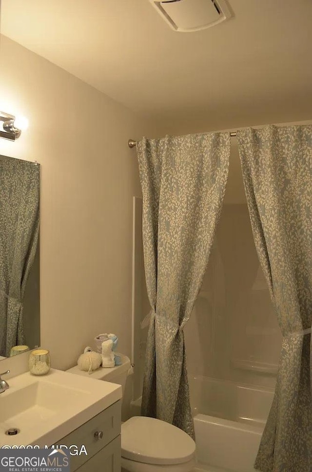 full bathroom with shower / tub combo, vanity, and toilet