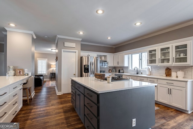 kitchen featuring white cabinetry, sink, gray cabinets, and appliances with stainless steel finishes