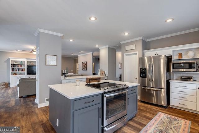 kitchen with white cabinetry, appliances with stainless steel finishes, a center island, and gray cabinetry