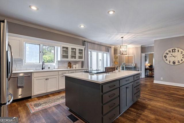254 Ridgewood Rd, Clarkesville, GA 30523 - kitchen with stainless steel appliances, a sink, white cabinets, crown molding, and a chandelier
