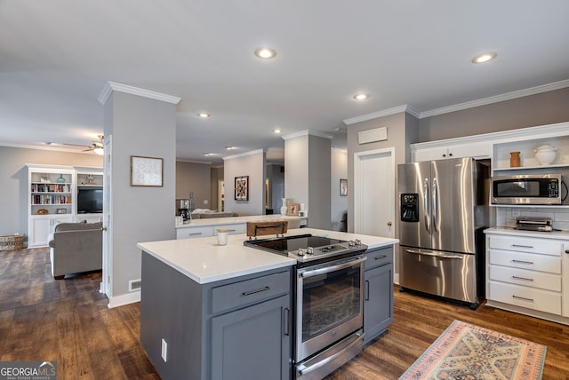 254 Ridgewood Rd, Clarkesville, GA 30523 - kitchen featuring stainless steel appliances, light countertops, ornamental molding, a kitchen island, and dark wood-style floors