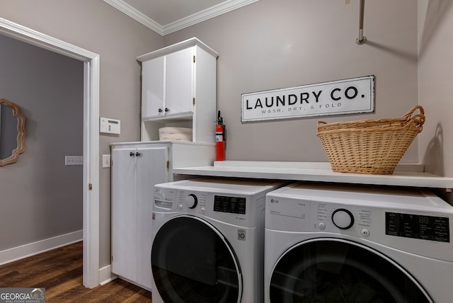 laundry room featuring cabinets, ornamental molding, washer and dryer, and dark hardwood / wood-style flooring