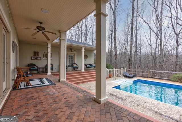 view of pool with ceiling fan and a patio