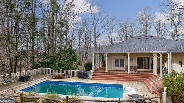 view of swimming pool featuring french doors, a patio area, ceiling fan, a grill, and a deck