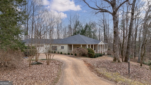 single story home with a garage and covered porch