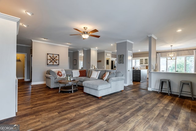 living room featuring ceiling fan with notable chandelier and dark hardwood / wood-style flooring