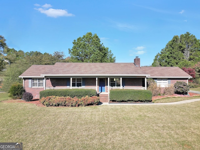 ranch-style home featuring a porch and a front yard