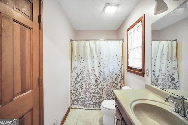 bathroom with vanity, a textured ceiling, tile patterned floors, toilet, and walk in shower