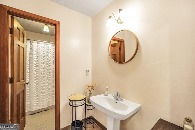 bathroom with sink and a textured ceiling