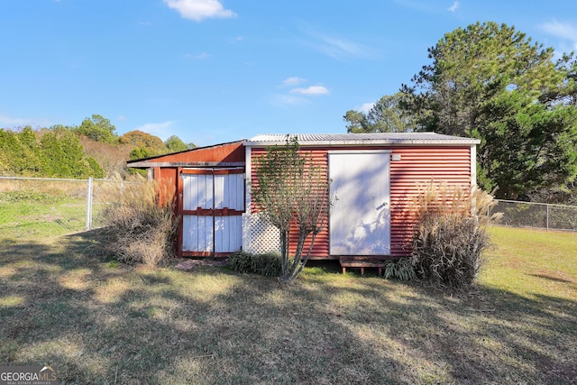 view of outbuilding with a yard