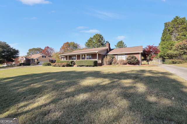 single story home with a garage and a front lawn