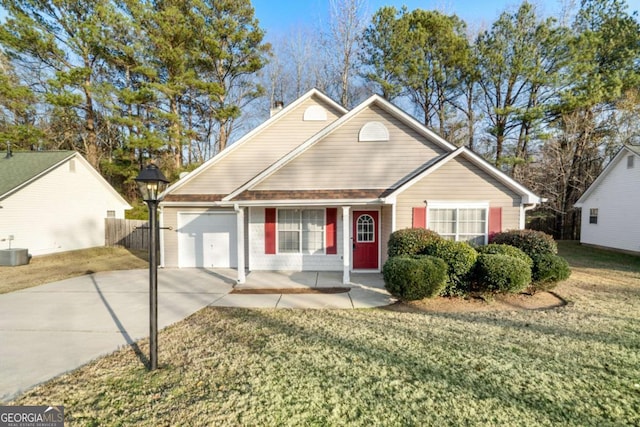 view of front of house featuring central AC, a garage, and a front lawn