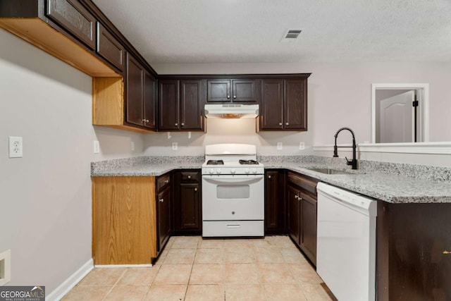 kitchen featuring white appliances, dark brown cabinetry, sink, and light tile patterned floors