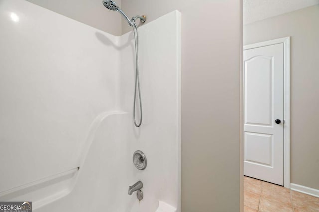 bathroom with tile patterned flooring and tub / shower combination