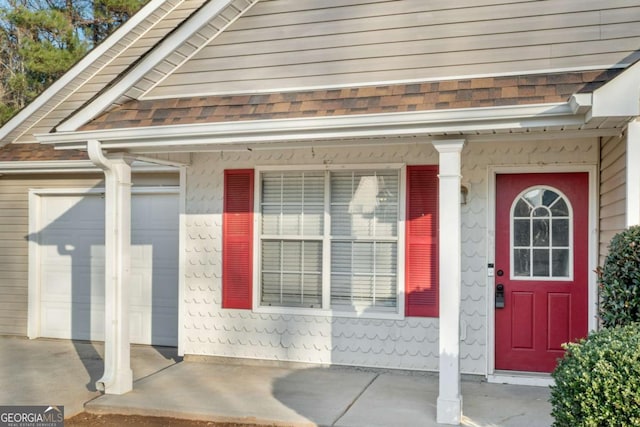 property entrance featuring a garage and covered porch