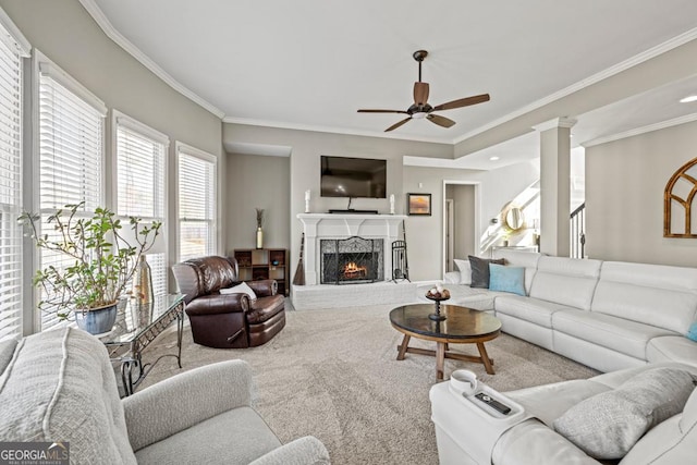 living room featuring ornate columns, ornamental molding, carpet floors, and ceiling fan