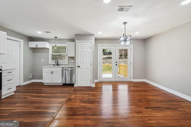 kitchen featuring french doors, hanging light fixtures, stainless steel dishwasher, dark hardwood / wood-style flooring, and white cabinets