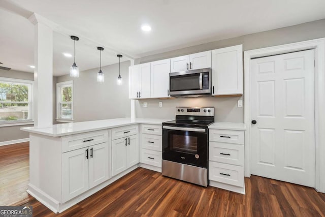 kitchen with white cabinetry, appliances with stainless steel finishes, and kitchen peninsula