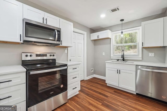 kitchen with sink, stainless steel appliances, and white cabinets