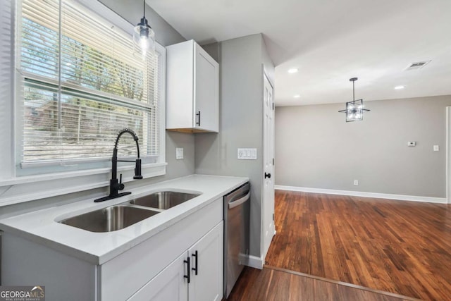 kitchen featuring hanging light fixtures, sink, dark wood-type flooring, and white cabinets