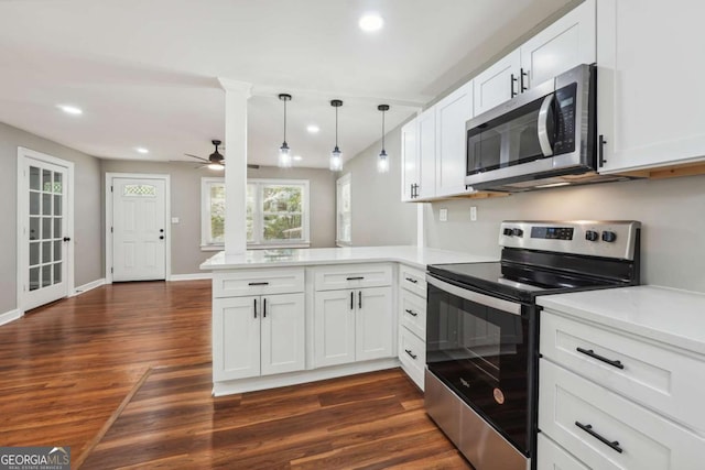 kitchen with pendant lighting, stainless steel appliances, dark hardwood / wood-style floors, white cabinets, and kitchen peninsula