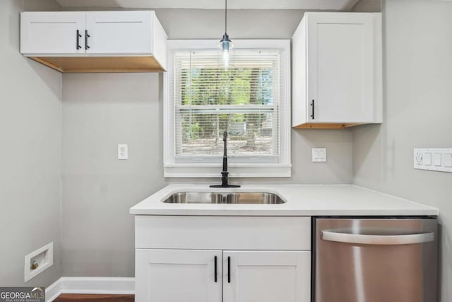 kitchen featuring pendant lighting, sink, white cabinets, and dishwasher