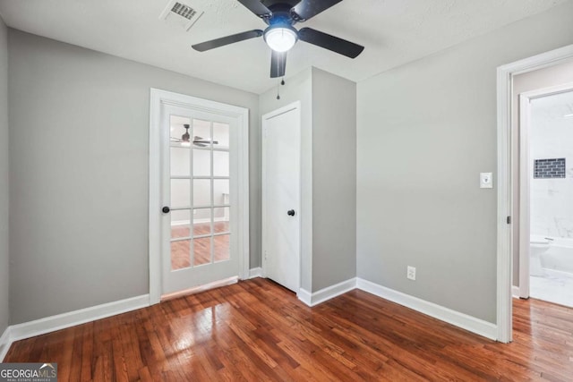 empty room with hardwood / wood-style floors and ceiling fan