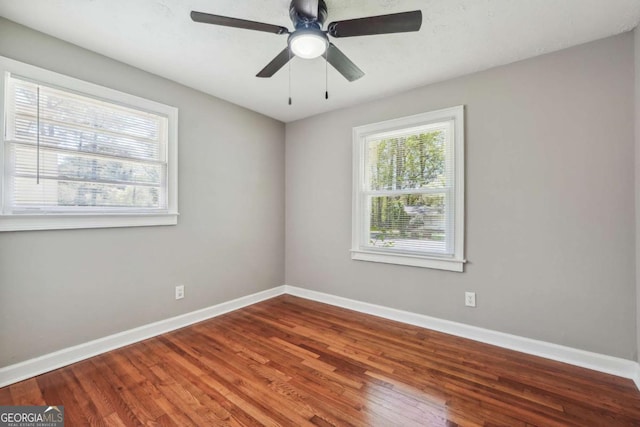 spare room featuring hardwood / wood-style flooring and ceiling fan