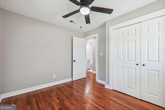 unfurnished bedroom featuring wood-type flooring, ceiling fan, and a closet