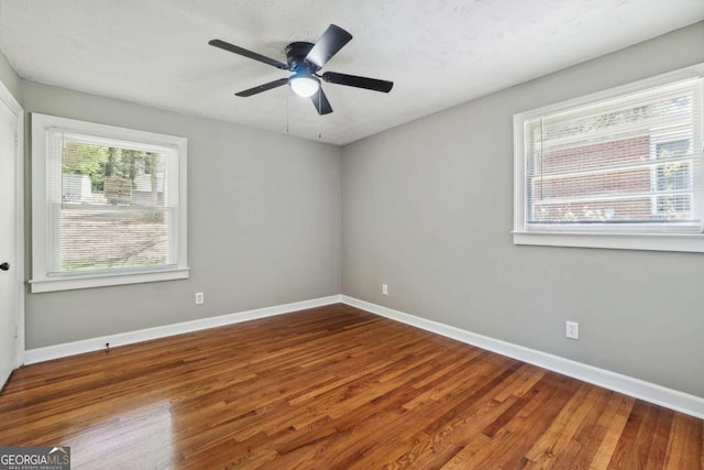 spare room with wood-type flooring and ceiling fan