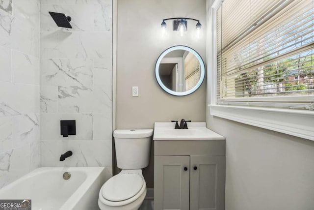 full bathroom with tiled shower / bath, vanity, and toilet