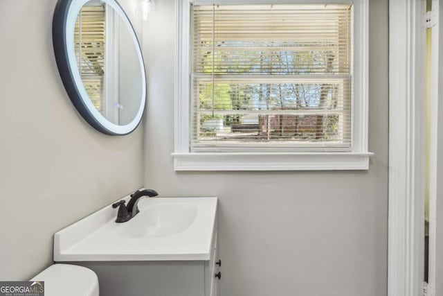 bathroom featuring vanity and toilet