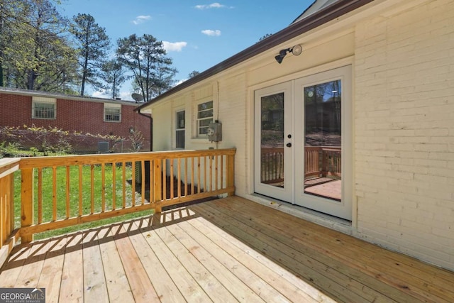 deck with french doors and a yard