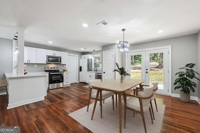 dining room featuring dark wood-type flooring and french doors