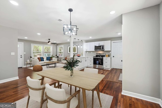 dining area with dark hardwood / wood-style flooring and a chandelier