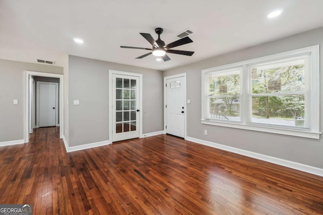 interior space with dark wood-type flooring and ceiling fan