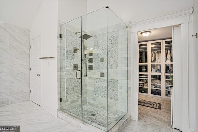 bathroom featuring tile walls and a shower with door