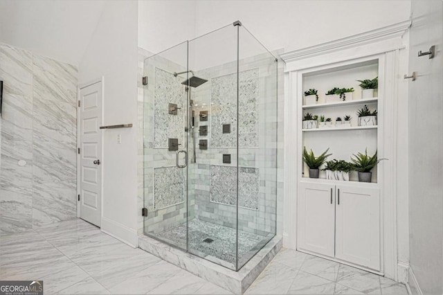 bathroom featuring a shower with shower door and vaulted ceiling