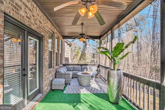 unfurnished sunroom featuring ceiling fan