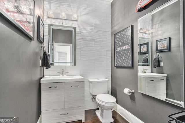 bathroom featuring vanity, toilet, and wood-type flooring