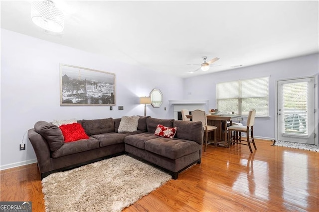 living room with hardwood / wood-style flooring and ceiling fan