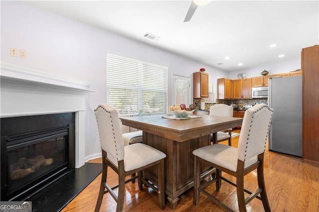 dining room featuring ceiling fan and light hardwood / wood-style flooring