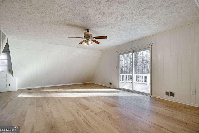 spare room featuring ceiling fan, a textured ceiling, and light wood-type flooring