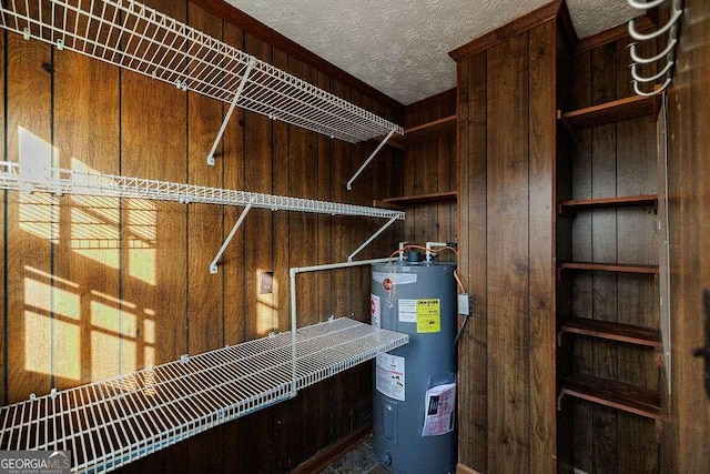 utility room featuring water heater