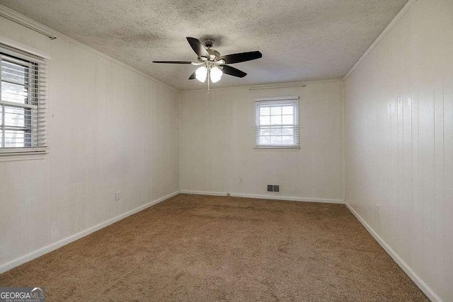 unfurnished room featuring carpet floors, ornamental molding, and a textured ceiling