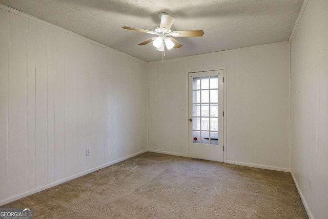 unfurnished room with ceiling fan, ornamental molding, light carpet, and a textured ceiling