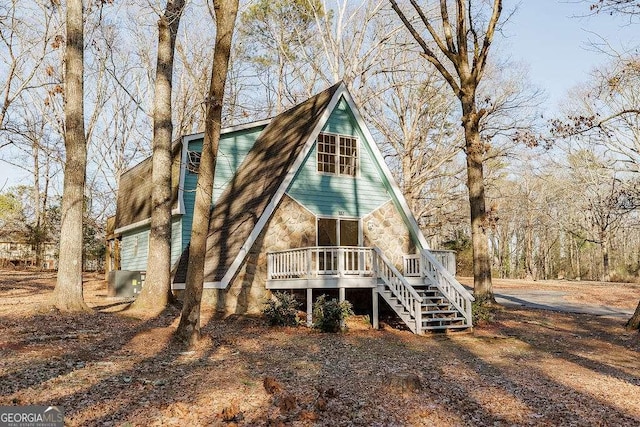 rear view of property with a wooden deck